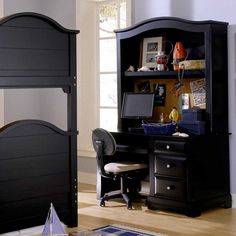 a bedroom with a bed, desk and bookcase in black wood finish on the floor