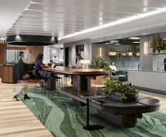 an office with people sitting at desks and plants on the tables in front of them