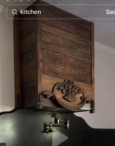 a kitchen stove top with a wooden cabinet above it