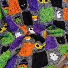 there is a crocheted blanket with halloween decorations on it