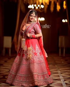 a woman in a red and gold bridal gown