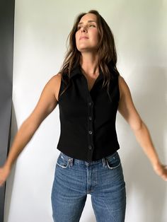 Button up, collared sleeveless top. Not cropped. Stretchy, knit fabric. Color: black HOW TO STYLELooks fantastic with a basic pair of high waist denim. Would pair well with trousers for a business casual look and under blazers for an easy, polished layer. SIZINGSlightly small - size up if you want it to fit looser. 95% cotton, 5% spandex Shoulder to hem: 19" (sz S) Collared Sleeveless Top, High Waist Denim, Collar Top, Black Sleeveless, Winter Accessories, High Waisted Denim, Autumn Summer, A Business, Fabric Color