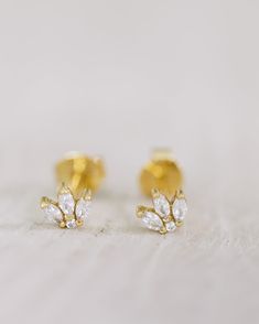 Crafted from gold-vermeil with a cluster of crystals, these earrings make the perfect finishing touch for any look. Dainty and delicate, these earrings will add just the right amount of sparkle. Gold Cluster Earrings With Cubic Zirconia, Sparkling Gold Cluster Earrings For Anniversary, Gold Cluster Earrings In 14k, Gold Cluster Earrings For Anniversary, Gold Cluster Jewelry With Sparkling Stones, Sparkling 14k Gold Earrings For Wedding, Sparkling 14k Gold Wedding Earrings, Gold Flower Earrings With Sparkling Stones For Gift, Gold Dainty Crystal Earrings For Anniversary