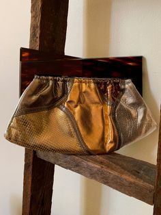 Offering an amazing, Snakeskin Patchwork Clutch Handbag, in gold, rose gold, silver & bronze. With zig zag top-stitching. Not labeled, but unmistakably Bags by Varon. With a pair of juxtaposed geometric triangular handles in a faux tortoise shell lucite that pulls open & snaps shut on a V-hinged frame. A fabulous vintage art accessory to wear. Circa 1960s. The bag is 6 inches high, including the lucite handles, and measures 9 3/4 inches along the bottom at its longest. The V-hinge is ful Patchwork Clutch, Men Mode, Hinged Frame, Vintage Suitcase, Metallic Shoes, Hand Painted Leather, Art To Wear, Change Purse, Art Accessories