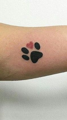 a person with a dog paw tattoo on their arm