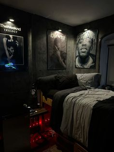 a bed room with a neatly made bed and posters on the wall