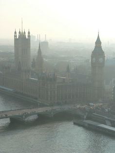 the big ben clock tower towering over the city of london, england in foggy weather