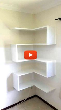 an empty room with shelves on the wall