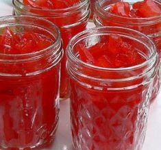 several jars filled with jelly sitting on top of a table