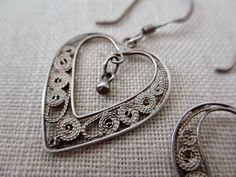 This listing is for a pair of sterling silver earrings with a filigree design. great condition, lightweight Each measures 20mm long, 18mm wide (32mm long from the top of the ear wire) stamped '925' on the wire Heart-shaped Filigree Earrings For Gift, Silver Heart Pendant Earrings For Wedding, Silver Heart Pendant Wedding Earrings, Silver Heart Shaped Drop Earrings, Silver Double Heart Pierced Earrings, Handmade Silver Heart Pendant Earrings, Silver Heart-shaped Pierced Earrings, Vintage Sterling Silver Pierced Heart Earrings, Vintage Style Sterling Silver Pierced Heart Earrings