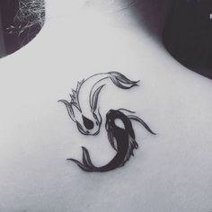 the back of a woman's neck with a black and white tattoo design on it