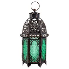 an ornate metal lantern with green glass in the middle and a circular handle on top