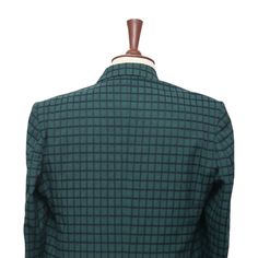 This Chiragh Apparel blazer is an elegant upgrade on dapper tailoring and features rich shades in a sumptuous fabric for elegant opulence. Fashioned from premium quality wool, this check plaid blazer features full lining in Japanese silk, a notch lapel, two-button closure and single-vented back. A left chest pocket and three flap pockets appoint the front while the inside has two (2) pockets on the left and one (1) pocket on the right. A flash of contrast piping is added to the jacket lining ins Elegant Fitted Nehru Jacket For Workwear, Fitted Long Sleeve Tweed Jacket With Hidden Buttons, Fitted Nehru Jacket For Business, Fitted Nehru Jacket For Semi-formal Events, Fitted Semi-formal Nehru Jacket With Suit Collar, Fitted Nehru Jacket With Notch Lapel For Work, Tailored Long Sleeve Bandhgala, Fitted Tweed Jacket With Long Sleeves For Semi-formal Occasions, Fitted Green Tweed Jacket For Semi-formal Occasions