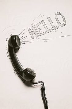 an old fashioned telephone with the word hello written on it's wall behind it