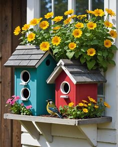 two bird houses with flowers in the window sill and sunflowers growing out of them