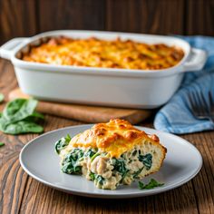 a casserole dish with spinach and chicken in it on a white plate