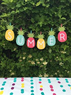 a banner that says summer with pineapples hanging from the top and polka dots on the bottom