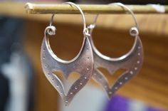 Traditional Cheap Metal Earrings, Unique Sterling Silver Hoop Earrings For Pierced Ears, Artisan Handmade Silver Hoop Earrings, Symbolic Silver Hoop Earrings With Ear Wire, Handmade Earrings For Anniversary, Traditional Handmade Hoop Earrings For Anniversary, Handmade Earrings For Anniversary And Festivals, Bohemian Sterling Silver Pierced Plug Earrings, Handmade Silver Drop Cartilage Earrings