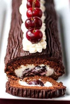 chocolate cake with cherries and whipped cream on top