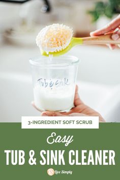 a person holding a spoon with a tub and sink cleaner in it that says, 3 ingredient soft scrub easy