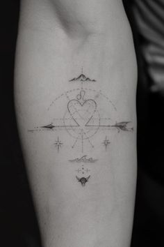 a heart and arrows tattoo on the arm