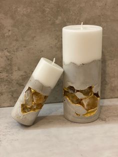 two white candles sitting next to each other