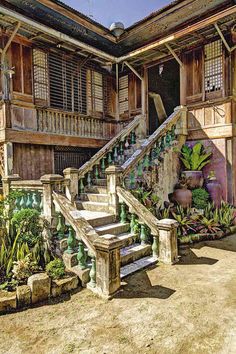 an old house with plants and stairs