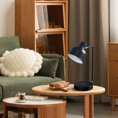 a living room scene with focus on the couch and coffee table in the foreground