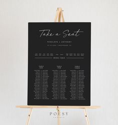 a black and white wedding seating chart on an easel