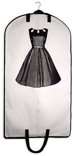 a white and black bag with a dress drawn on the front, hanging from it's side