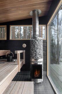 a room with a fire place inside of it next to a wooden table and bench