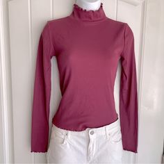 Petal Mauve Forever 21 Lettuce Edge Ribbed Long Sleeve Mock Neck Top Small Nwot. This Gorgeous Cotton-Blend Top Is A Classic Yet Spicy Piece To Pair With Boots And Jeans Or A Skirt. It Is New Without Tags, And In Immaculate Condition. Measurements Are 16” Pit-To-Pit, And 20” In Length. The Top Does Have A Little Bit Of Stretch To It. (Fits A Little On The Shorter Side; Most Regular Tops Are About 23”.) Comes From A Smoke-Free, Doggo Loving Home :) Purple Ribbed Stretch Top, Purple Stretch Ribbed Tops, Stretch Purple Ribbed Tops, Stretch Ribbed Purple Tops, Purple Tops For Fall Layering, Purple Stretch Tops For Winter, Purple Stretch Top For Winter, Purple Stretch Winter Tops, Trendy Fitted Mauve Tops