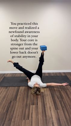 a woman is doing yoga on the floor with her arms in the air and one hand up above her head