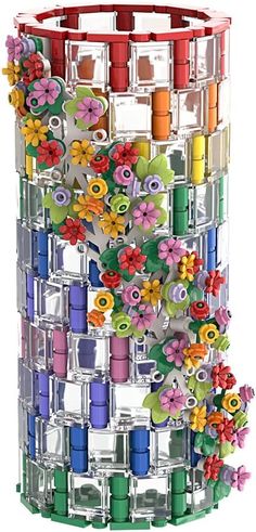 a multicolored vase filled with lots of thread and spools