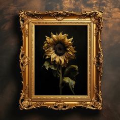 a painting of a yellow sunflower in a gold frame on a wall with dark background