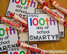 the 100th day of school smart cards are on top of a table with candy sticks