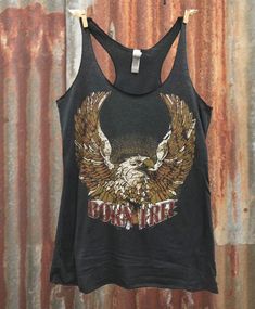 Country Deep Born Free racerback tank top Feel the vintage 70's vibes in our vintage-inspired Born Free tri-blend, black women's racerback tank top.  4.3 oz. 50% Poly 25% Cotton 25% Rayon; fits 1/3 size bigger than normal size for a looser fit Biker Chick Outfit, Plus Size Crop Tops, Rock And Roll Fashion, Cutout Shorts, Born Free, Plus Size Tank Tops, Top Seller, Tankini Top, Racer Back