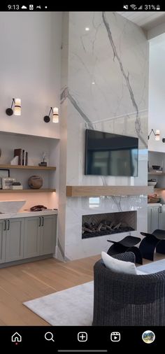 a living room filled with furniture and a flat screen tv mounted on the wall above a fireplace