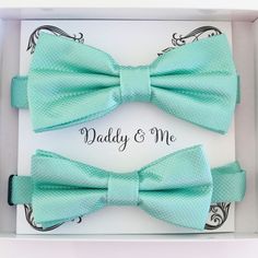 "Aqua blue Bow tie set for daddy and son, Daddy and me bow tie gift set, Grandpa me, Handmade Adjustable pre tied bow  Some thing blue Color of bow tie: Aqua Adult bow: Bow size: 5\" (width) and 2.5\" (height)  Neck Size (Adjustable): (11'' - 19'')   Kids bow : Bow size: 4\"(width) and 2\" (height) Neck Size (Adjustable): (10\"- 17\")  Box Size:  5\" x 6\" The color of Note Card Paper: White (custom order accepted) Email Us For Further Customization Options & Details! We're Happy To Help" Blue Standard Bow Tie For Father's Day, Blue Bow Tie For Father's Day, Blue Bow Tie For Party Or Father's Day, Blue Bow Tie As A Gift, Blue Tie With Bow Tie Back As A Gift, Blue Bow Tie For Wedding And Father's Day, Green Ties For Father's Day, Adjustable Satin Bow For Gifts, Green Bow Tie For Father's Day Gift