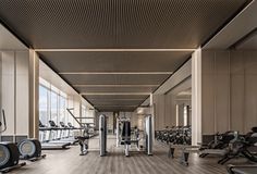 an empty gym with rows of treadmills and exercise machines