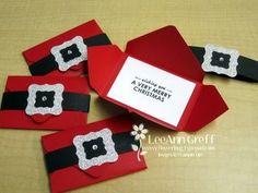 four red boxes with black and white designs on them, one has a card that says merry christmas