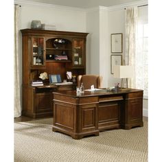 an executive desk with chair and hutch in the corner