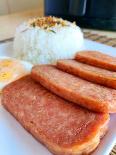 some sausages and rice on a white plate