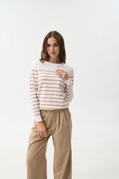 This trendy striped sweater in beige and white is a must-have for the new season. The neutral beige color can be harmoniously combined with various shades of blue denim, caramel, brown, and gray. The simple design makes it easy to pair the sweater with jeans, pants, and skirts of different styles. Our favorite choice is a cozy look with a blue denim palazzo and cowboy boots. Denim Palazzo, Striped Knit Sweater, Caramel Brown, Top Pants Set, Sweater Tank Top, Neutral Beige, Knitting Women Sweater, Beige Sweater, Striped Sweater