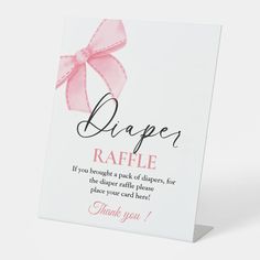 a greeting card with a pink bow on it's side that says, diaper raffle