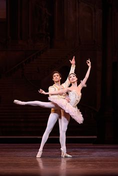 two ballerinas are performing on stage together