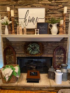 a fireplace with a sign above it that says home on top of the mantel