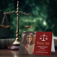 a thank you card sitting on top of a wooden table next to a judge's scale