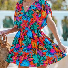 Capture The Essence Of A Tropical Paradise With Our Vibrant Tropical Surplice Mini Dress. The Vivid Hues And Exotic Patterns Transport You To Sun-Soaked Destinations, While The Surplice Neckline Adds A Touch Of Allure, Making This Mini Dress A Perfect Choice For Carefree Days And Lively Nights. Product Code: Caa05a4a007zz Features: Woven Surplice V-Neckline Short Dolman Sleeves Drawstring Shoulders Mini X-Shape Silhouette Pattern: Floral Material: 95%Polyester,5%Spandex New Never Worn Vibrant Floral Print Mini Dress For Beach, Vibrant Mini Dress With Floral Print For Beach, Vibrant Floral Mini Dress For Beach, Colorful V-neck Dress With Floral Print, Multicolor Mini Dress With Tropical Print For Garden Party, Vibrant Floral Print Mini Dress, Vibrant V-neck Dress With Tropical Print, Tropical V-neck Mini Dress With Floral Print, Tropical Floral Print V-neck Mini Dress