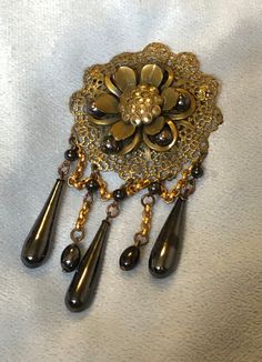 "Hello and Welcome to LiamBySevanna! Prior-purchasing any listing from this shop, please Ask question/s, Request additional photos, to make sure the listed item, is the right choice for you! Per our store policy we don't accept returns Listing is for;  Art Deco Floral Festoon Brooch Pin W/Enamel marcasite Genuine Hematite Stones ~ pin mechanism functions properly safe & secure ~ Brooch Center is a 3 dimensional Flower with hematite orbs & enamel petals ~ large Marcasite Stones at center ~ bottom festoon drapes are chained to matching larger drops and orbs ~ Brooch measures 4  inch drop length, by 2 inch wide ~ weights 33.2 grams ~ Hematite's are non-magnetic, natural stones ~ beautiful larger Art Deco brooch.  Reminder: You can \"always\" prevent any wrong purchase/s by Communicating, Inqu Silver Victorian Enamel Brooches, Victorian Handmade Pendant Brooches, Victorian Silver Enamel Brooches, Ornate Bronze Brooch Jewelry, Ornate Silver Enamel Brooches, Antique Clip-on Brooch Gift, Antique Clip-on Brooches As Gifts, Antique Clip-on Brooches For Gifts, Antique Clip-on Brooches As A Gift